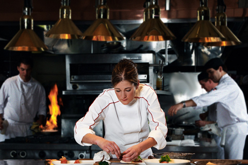 a person cooking in a kitchen preparing food